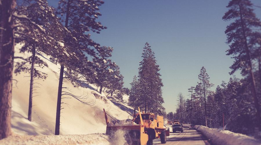 Truck plowing a snowy road