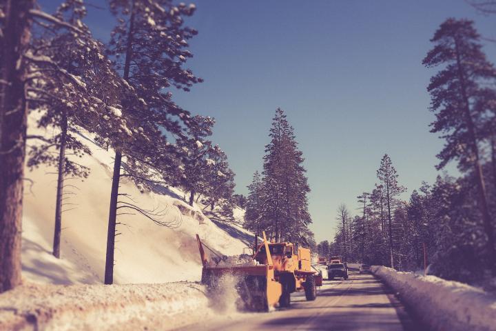 Truck plowing a snowy road